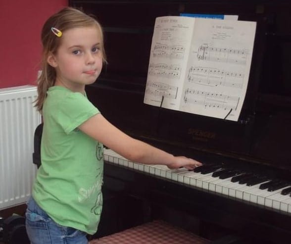 A picture of me playing my great grandmother's at about 8 years old